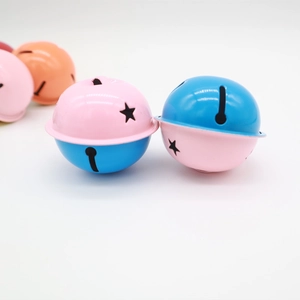 Macro view of colorful 4cm metal bells with star cutouts for DIY crafts and decor