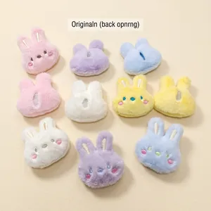 Colorful plush bunny head accessories with embroidered faces and back slit design