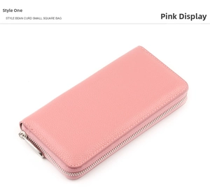 Macro shot of pink leather wallet with lychee grain texture and silver zipper detail