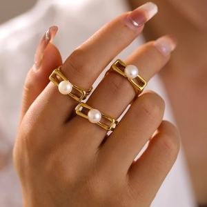 Three 18k gold plated stainless steel square rings with white pearls on model hand