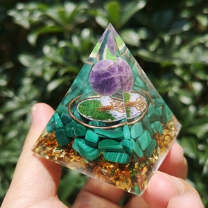 Detailed view of handmade crystal pyramid with amethyst and tree of life symbol