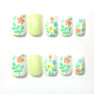Short square press-on nails with fresh floral patterns and light green color
