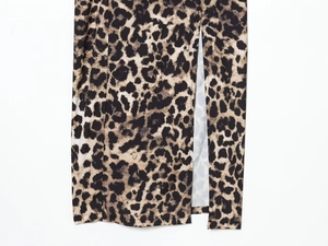 Detailed view of the leopard print maxi dress featuring a side slit and hemline stitching
