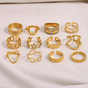 Detailed close-up of 12-piece gold-plated ring set with star, heart and zircon elements
