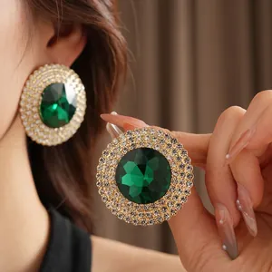 Luxury emerald green crystal earrings with white rhinestone halo in gold finish