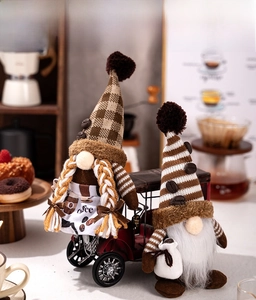 Detail of coffee gnomes with white braids and beard set on a vintage red car model decor