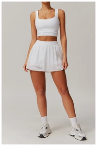 Front view of white square neck athletic crop top and high-waisted pleated tennis skirt