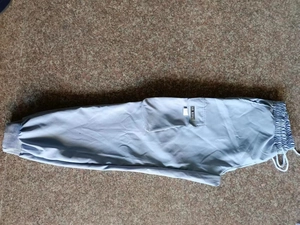 Detail von hellblauer Cargohose mit großen Seitentaschen und elastischem Kordelzug am Bund