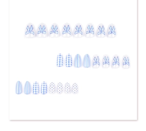 Detailed set of 24 blue and white press-on nails with bow and checkerboard patterns