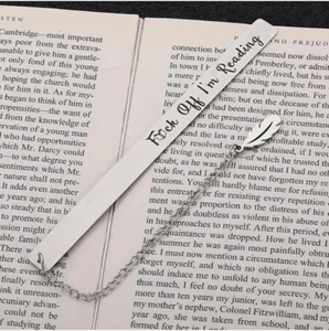 Silver stainless steel bookmark with feather charm featuring funny engraved quote on an open book
