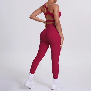 Detail of burgundy high-waisted yoga leggings and cutout back sports bra set