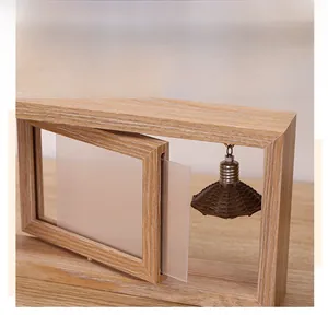Detail of wooden swivel photo frame showing natural grain and hanging heart pendant