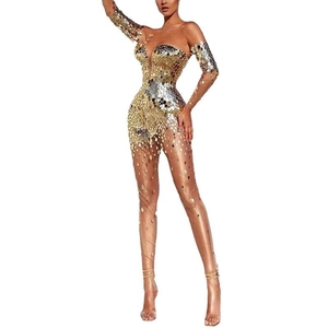 Macro detail of shimmering gold and silver sequins on sheer mesh evening gown
