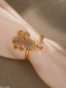 Detailed close-up of octopus-shaped gold ring with pave zircons on champagne satin
