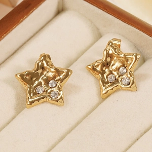 Star-shaped 18K gold plated earrings with zircon stones in a cream jewelry box