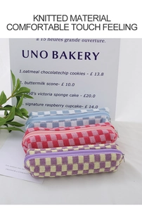 Close-up of colorful checkered knitted makeup bags in blue, pink, and purple patterns