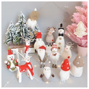 Macro detail of wool felt Christmas reindeer, snowman, and gnome holiday ornaments