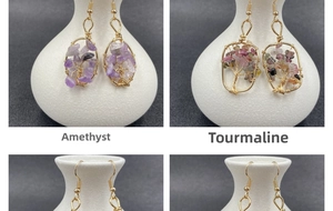 Detail view of four tree of life crystal earrings with amethyst and tourmaline stones