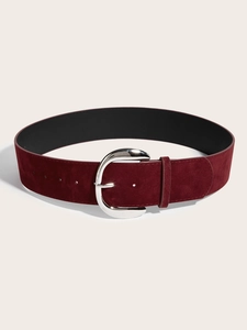 Detail of burgundy suede wide waist belt with a polished silver oval metal buckle