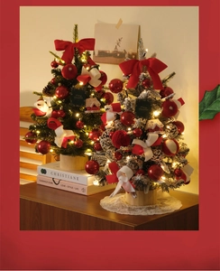 Detailed view of two mini DIY Christmas trees with warm LED lights and wooden base