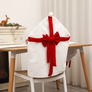Christmas chair covers in plush white and red velvet bow, festive holiday dining room decor