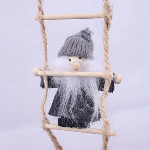 Detailed texture of wool felt Christmas gnome with white beard climbing a wooden rope ladder