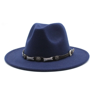 Close-up of a navy wool fedora hat featuring a leather band with silver star ornaments