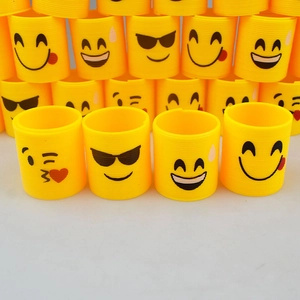 Yellow rainbow spring toy with various cute emoji smiley face patterns for children