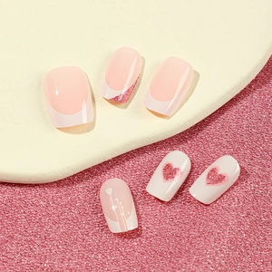 Pink and white French press-on nails with glitter hearts for Valentine's Day style