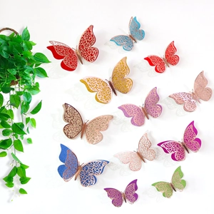 Close-up of 3D decorative paper butterflies with colorful hollow glitter on white wall
