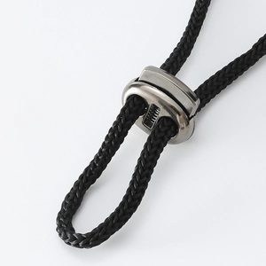 Detail of pet hat black woven strap with adjustable silver metal buckle and fiber texture