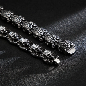 Macro shot of gothic skull bracelets in vintage steel finish with clear crystal inlay