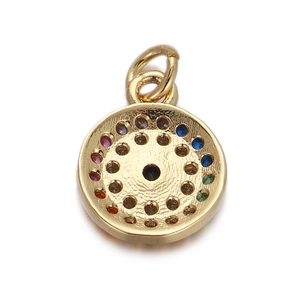 Close-up of hammered gold round pendant featuring colorful inset stones and a center gem