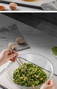 Close-up of a large transparent glass mixing bowl filled with fresh vegetable stuffing
