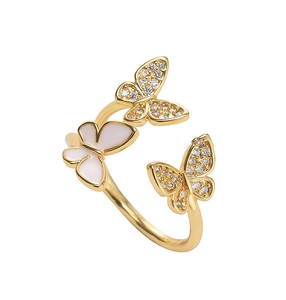 Detail of three-butterfly ring featuring white enamel wing and sparkling zircon stones
