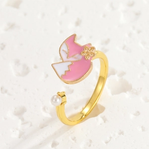 Detail of adjustable gold ring featuring a pink fox head and elegant white pearl