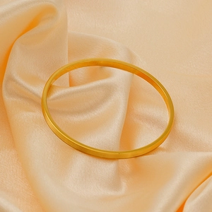 Detailed view of gold plated titanium steel bracelet with textured stripes on champagne silk