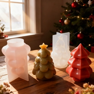 3D Christmas tree silicone molds and finished wax candles on a warm wooden surface