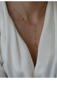 Close-up of minimalist 18k gold plated Y-necklace with elegant small beads on a model
