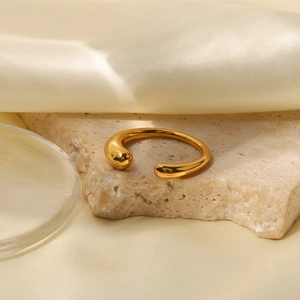 Detailed macro view of an 18K gold-plated stainless steel geometric open ring on stone