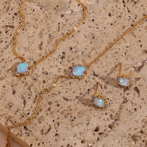 Macro detail of 18K gold plated necklace and earrings with opal and zircons