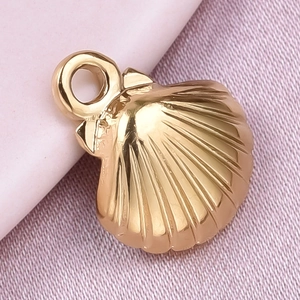 Macro shot of a golden shell pendant made of 304 stainless steel on soft fabric