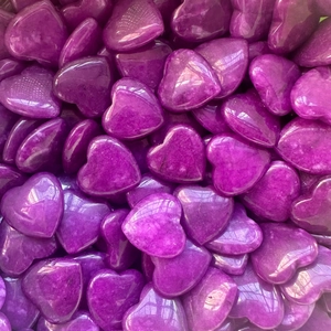 Macro shot of polished heart-shaped purple amethyst crystals for home decor