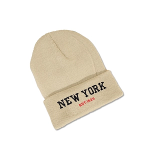 Close-up of beige knitted beanie featuring black and red New York embroidery detail
