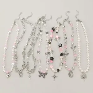 Detailed set of 8 Y2K necklaces featuring pearls, silver stars, and gothic cross charms