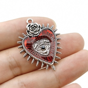 Gothic punk heart pendant with red eye and rose detail on silver metallic base