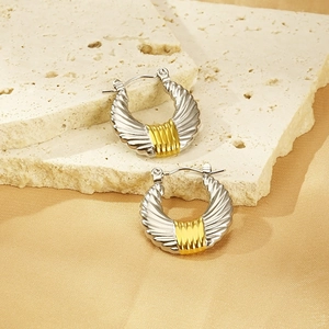 Detail view of 18k stainless steel U-shaped hoop earrings with shell textures on stone