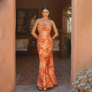Detail of elegant strapless orange marble print maxi dress with slim fit and silk-like fabric