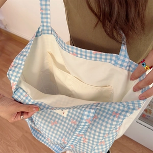 Blue and white checkered tote bag featuring pink bow print and internal double pockets