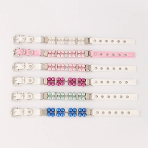Detailed view of six colorful faux pearl pet collars with rhinestone accents and PU leather